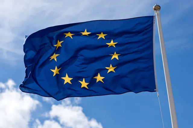 Close-up of the European Union flag, with gold stars on a blue field, symbolising the EU AI Act's pan-European scope.