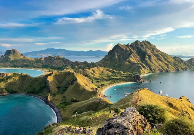 Aerial view of green volcanic islands and turquoise bays, a landscape evoking the natural resources GreenPT works to protect.